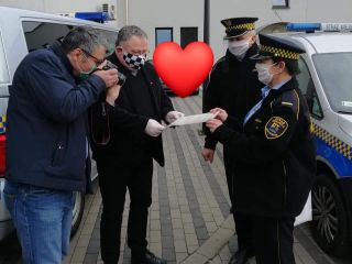 Wręcznie Ks Abp. Krzysztofowi Nieciągowi przez strazników miejskich podziękowań za przekazany sprzęt ochronny